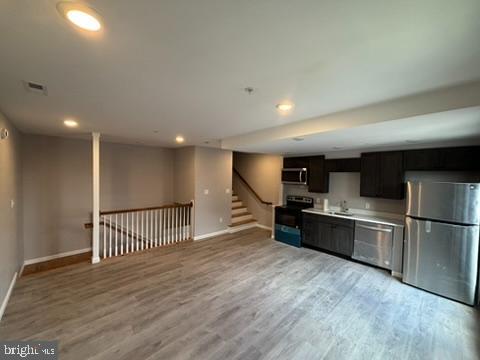 a kitchen with stainless steel appliances granite countertop a refrigerator and a stove