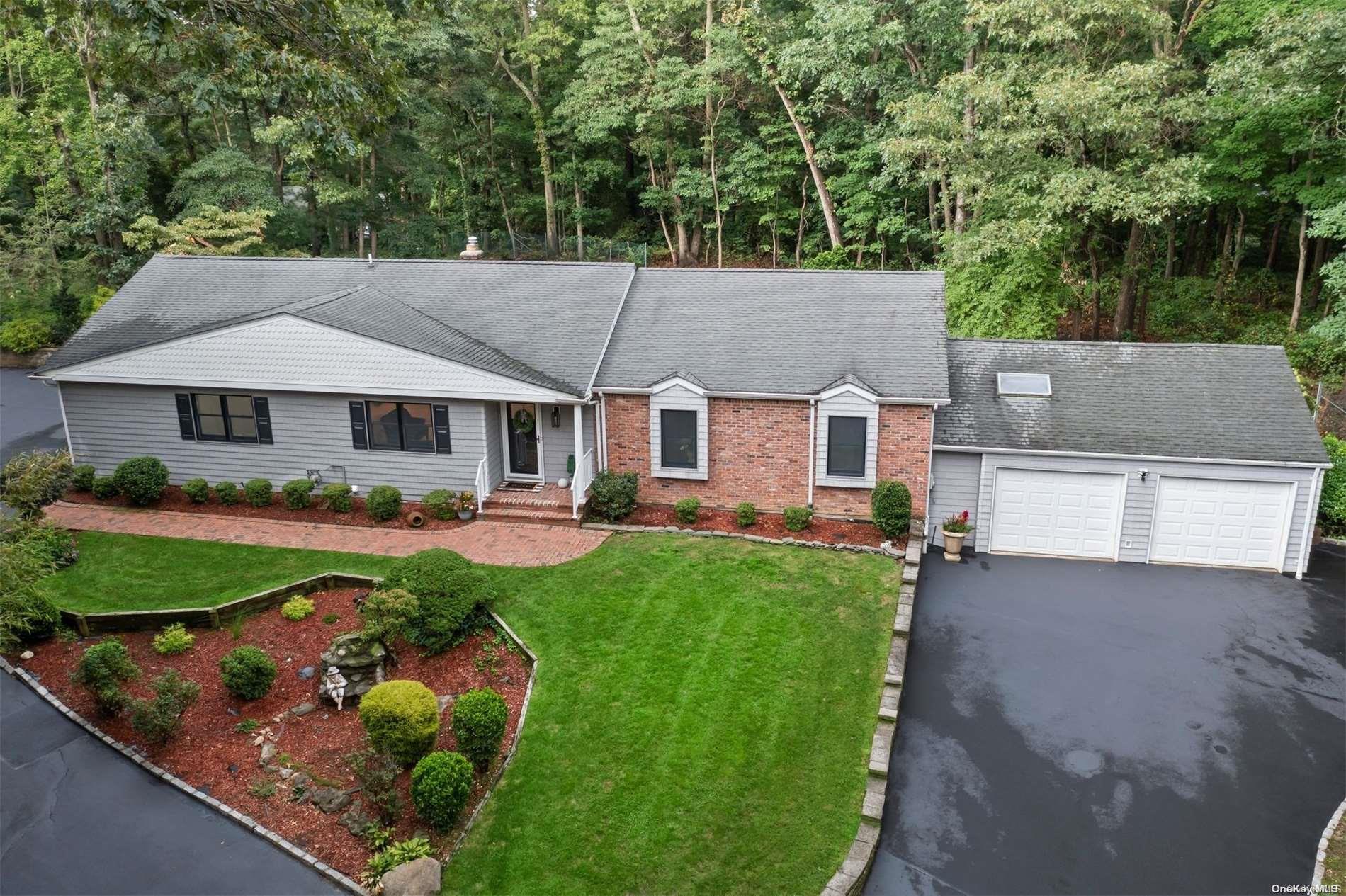 a aerial view of a house with table and chairs under an umbrella