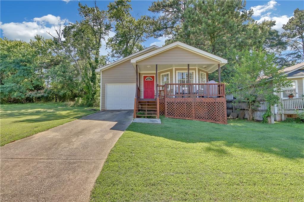 a front view of a house with a yard and porch