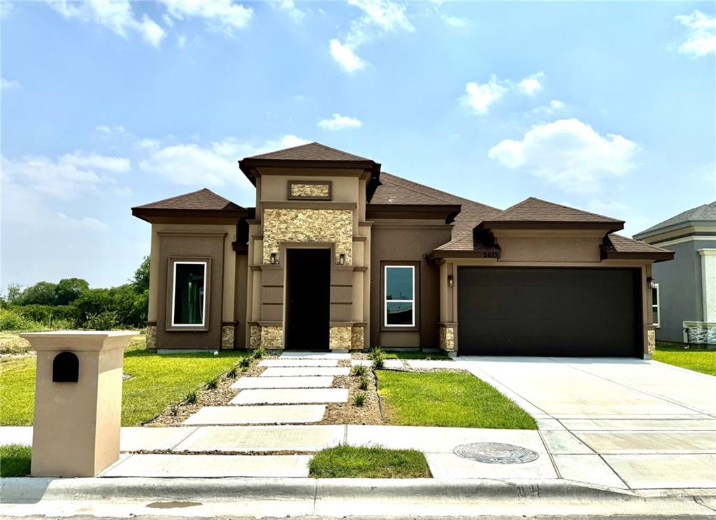 a front view of a house with a garden