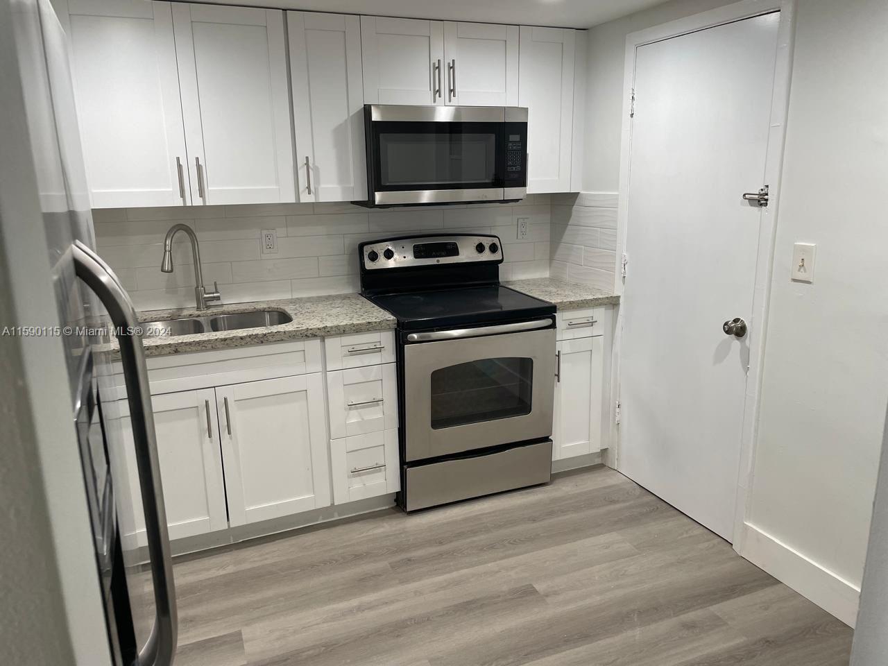 a kitchen with a stove and a microwave