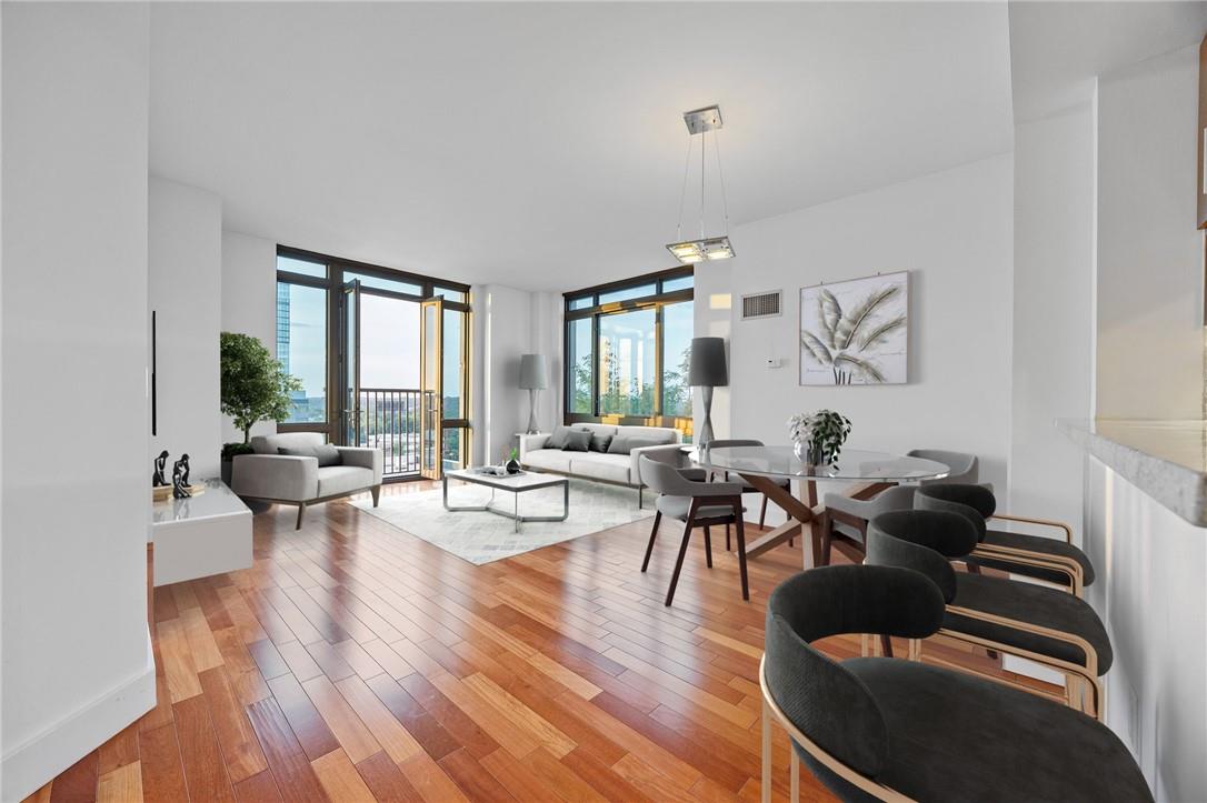 a living room with furniture and wooden floor