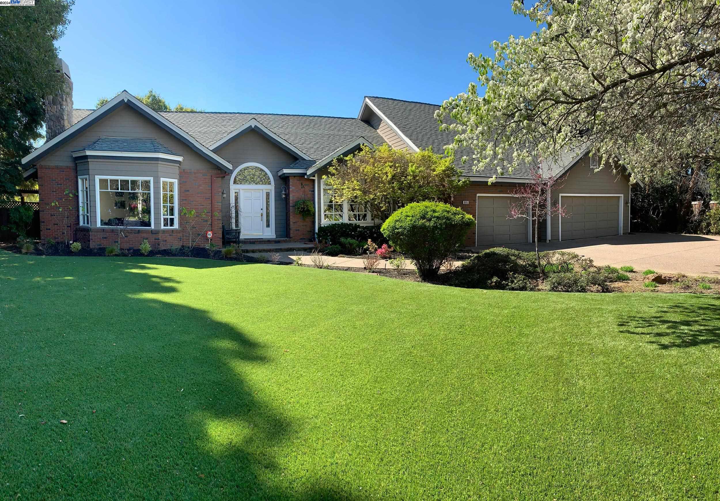 a front view of a house with a garden