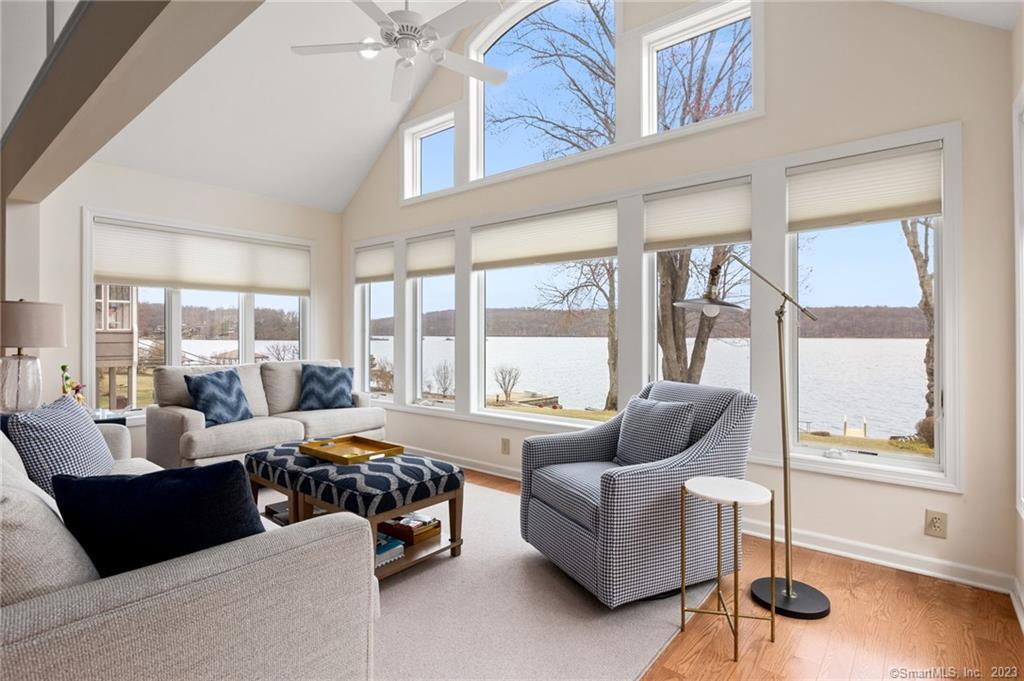 a bedroom with furniture and a large window