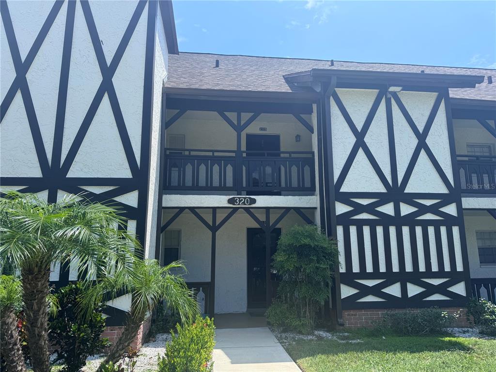 a view of front door and small yard