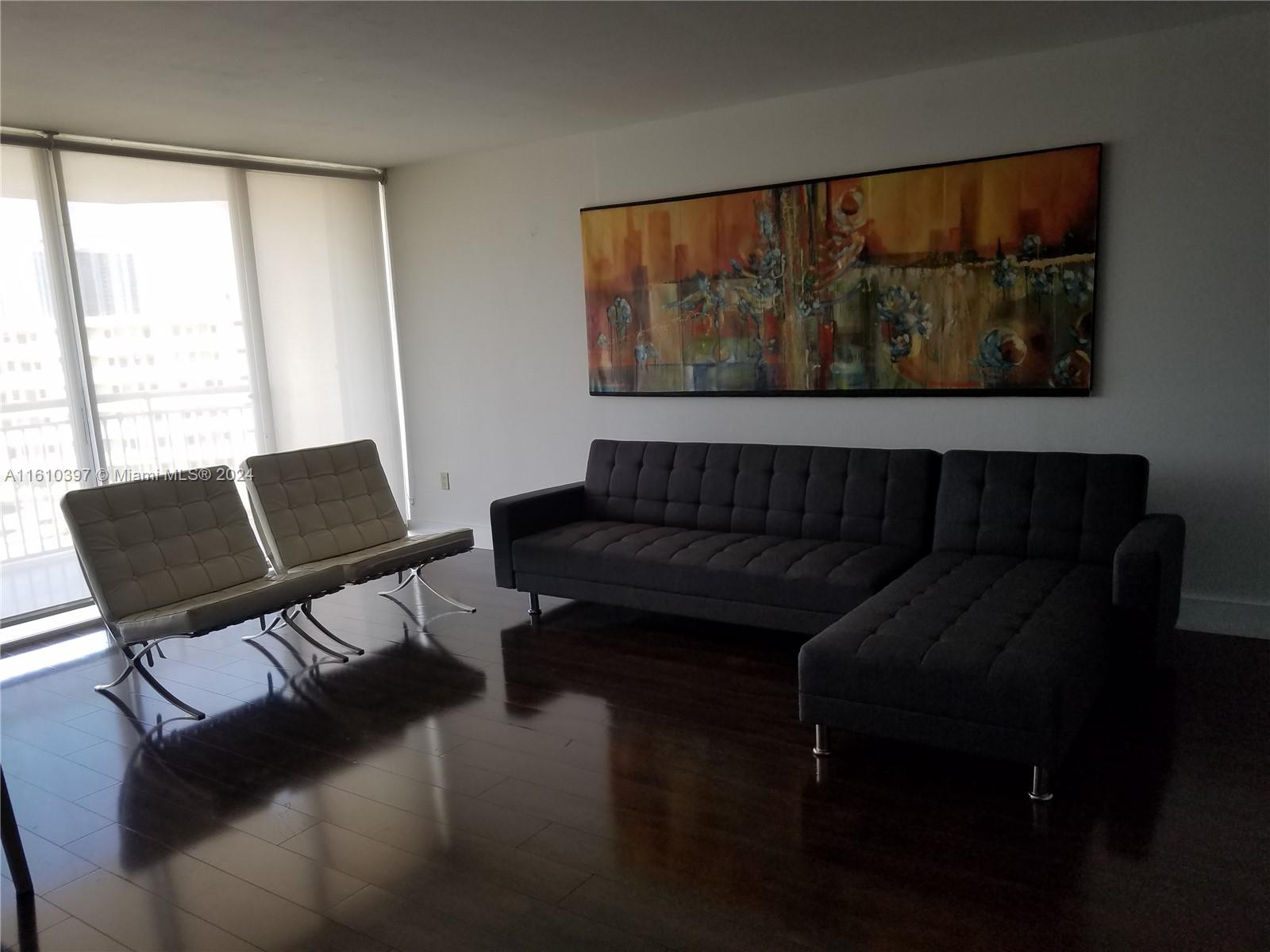 a living room with furniture and a large window