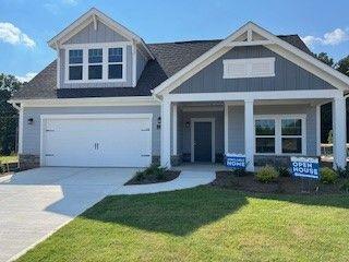 a front view of a house with a yard and porch