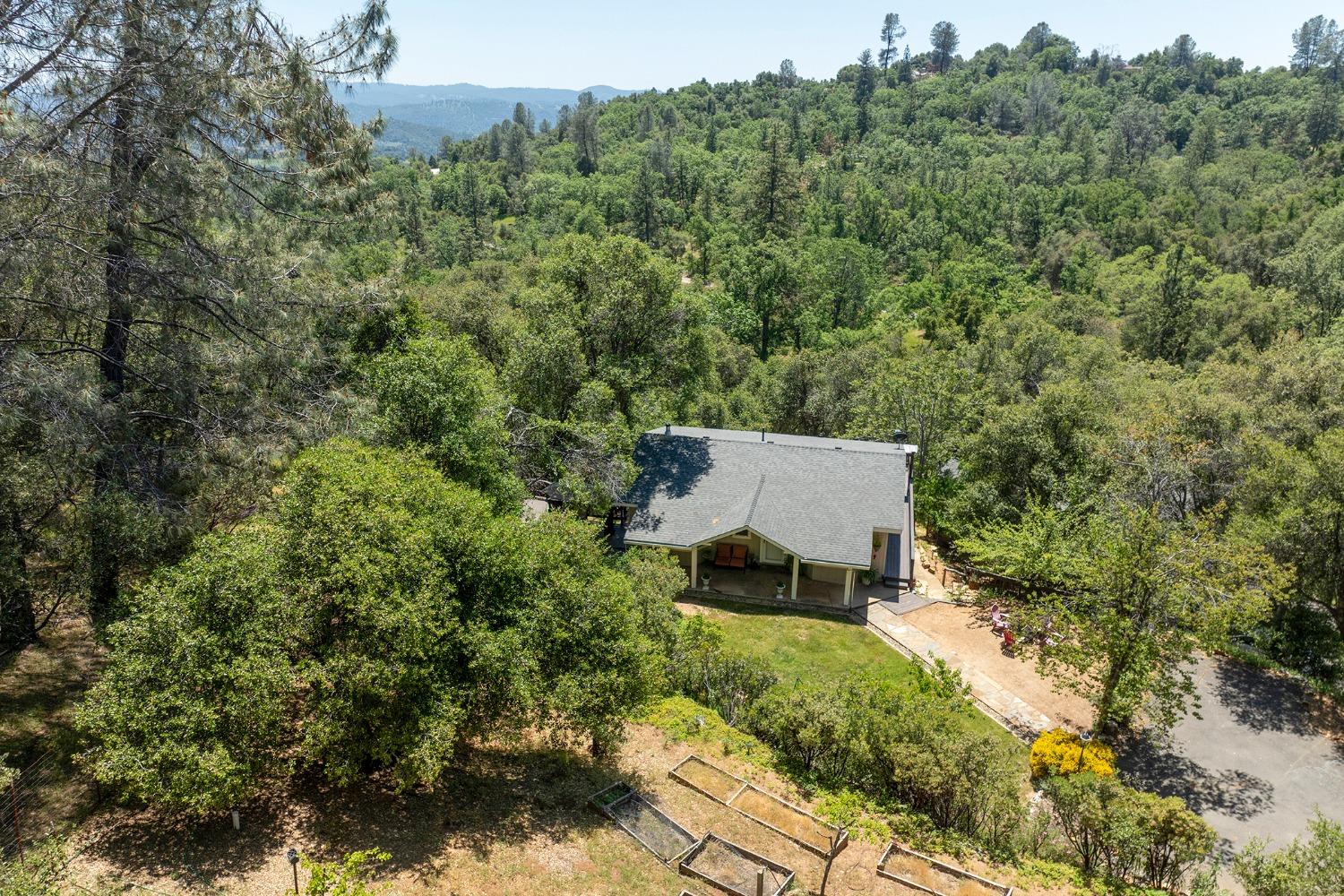 an aerial view of a house with a yard