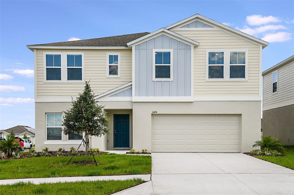 a front view of a house with a yard and garage