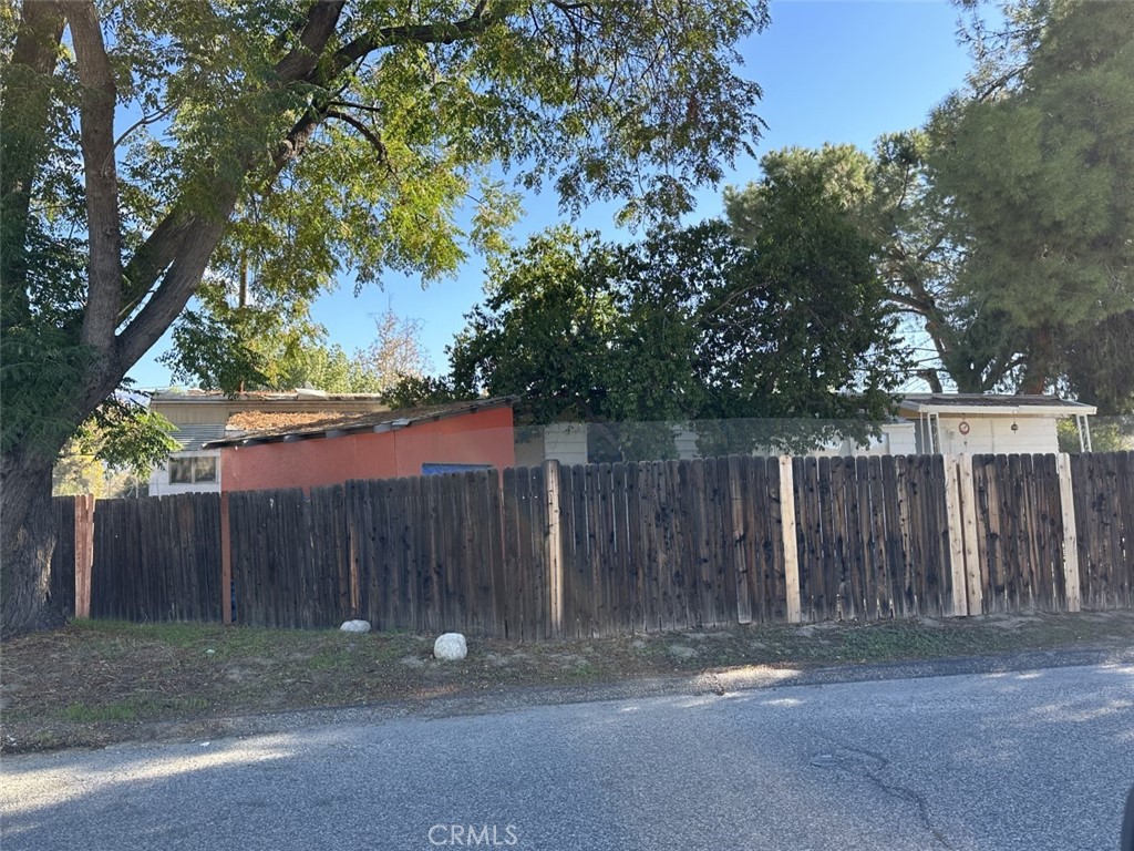 a backyard of a house with wooden fence