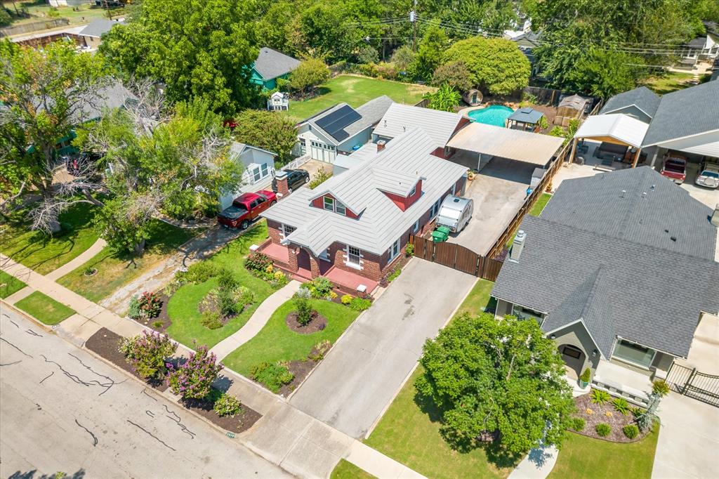 an aerial view of a house with a yard