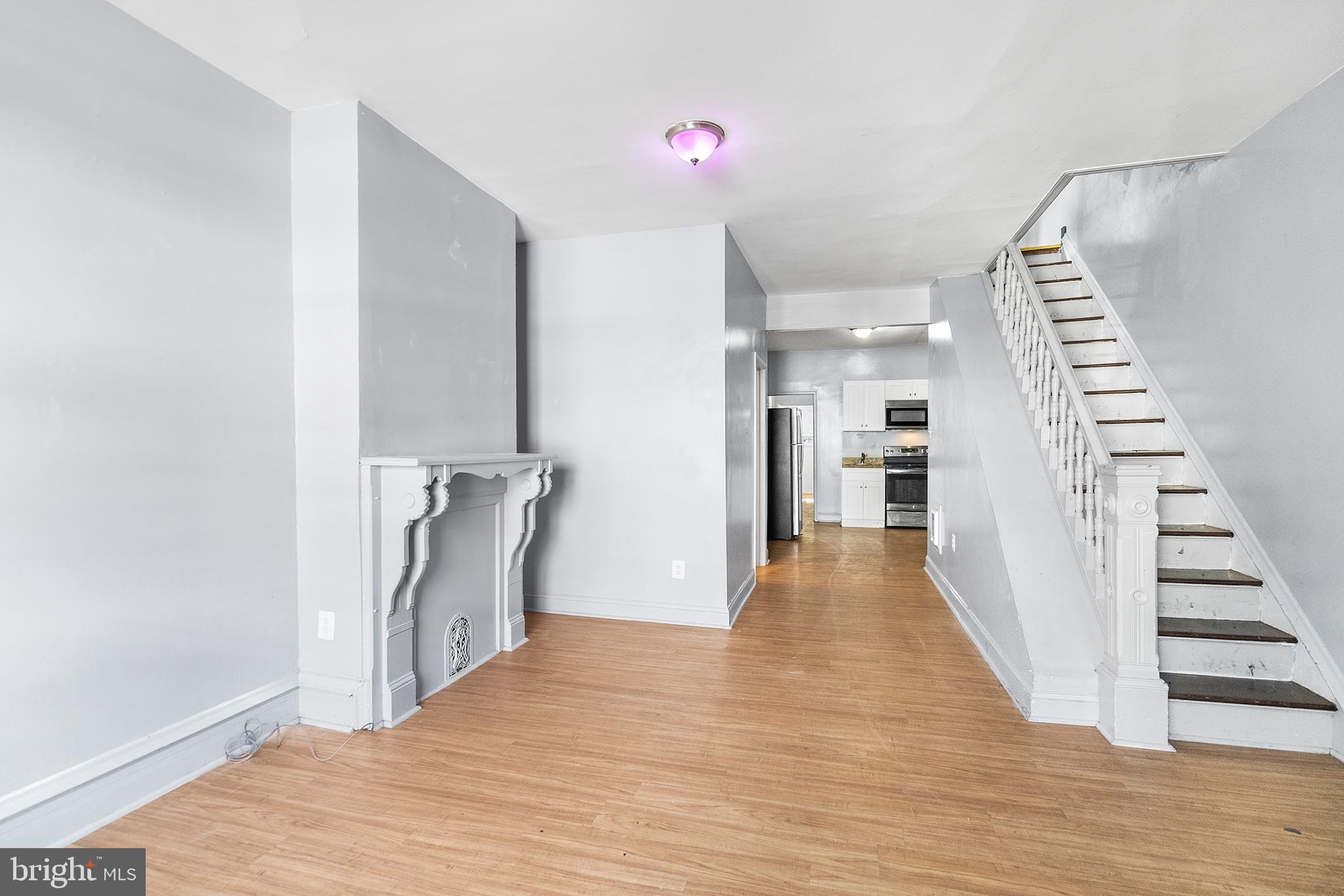 a view of hallway with stairs and wooden floor