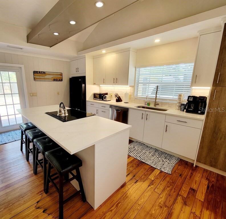 a kitchen with a table chairs refrigerator and cabinets