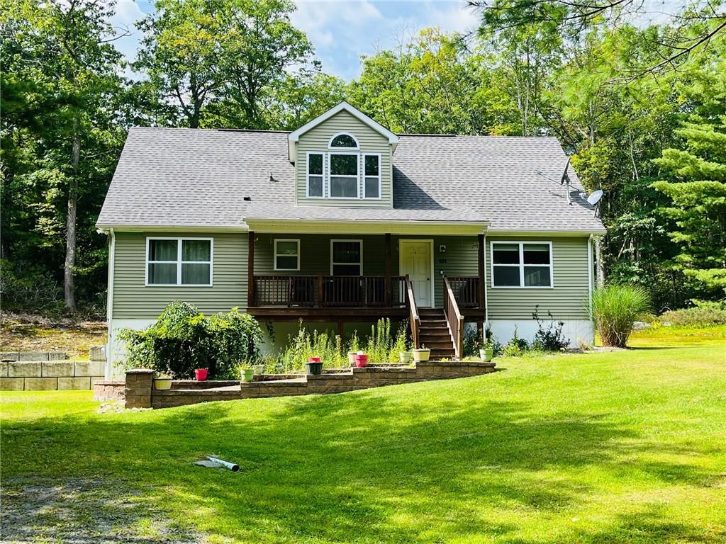 a front view of a house with a yard and porch