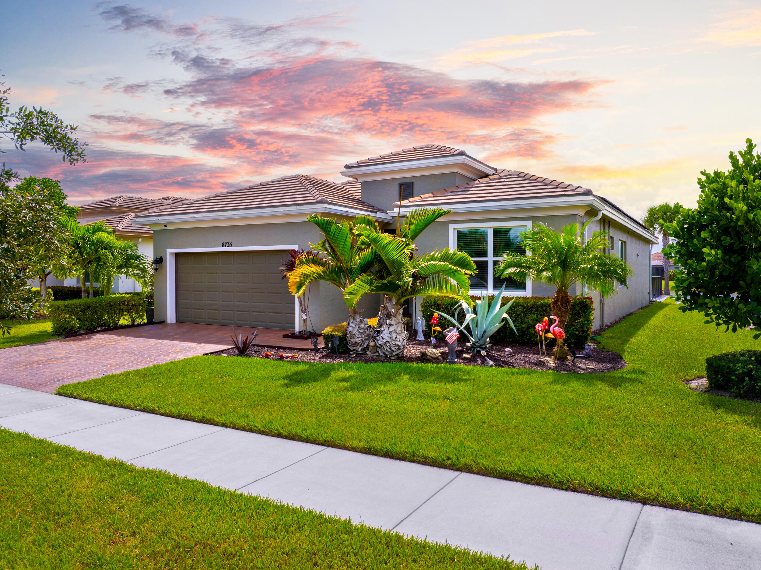 a view of a house with a yard and plants