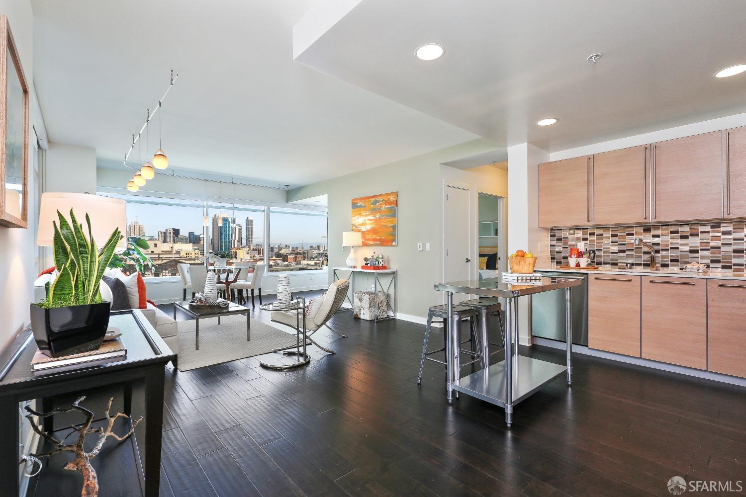 a view of a kitchen with dining table chairs and wooden floor