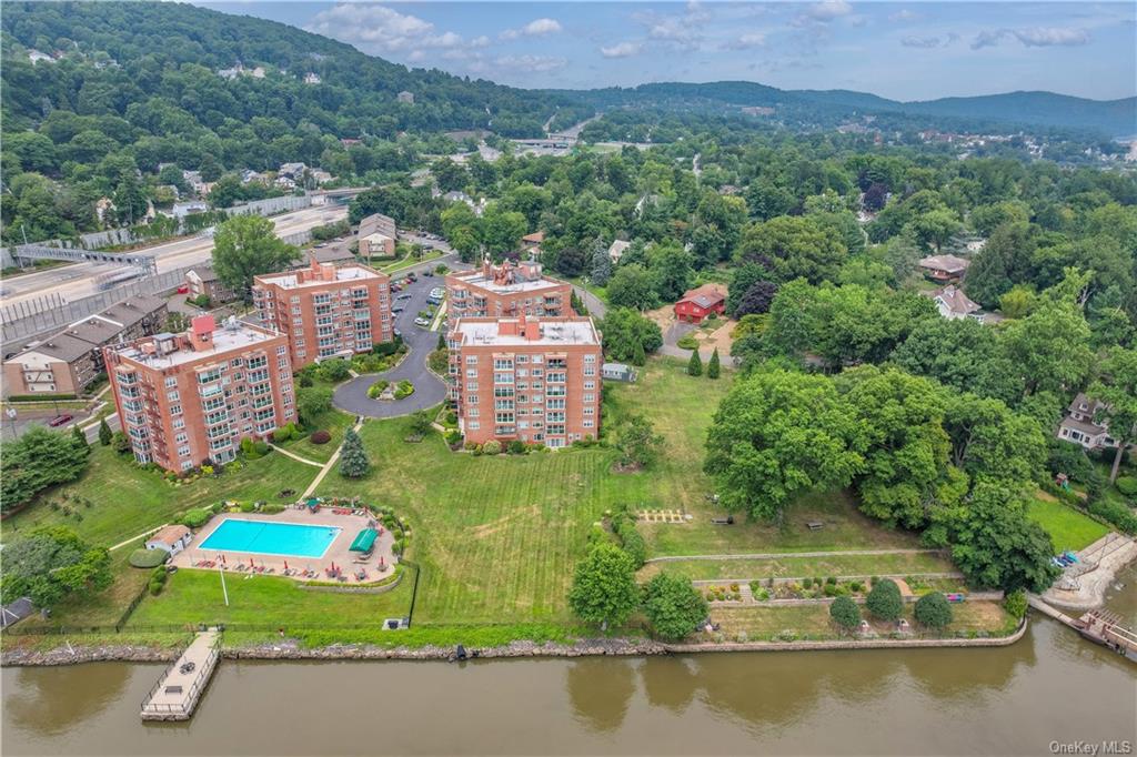 an aerial view of a house with a garden and lake view