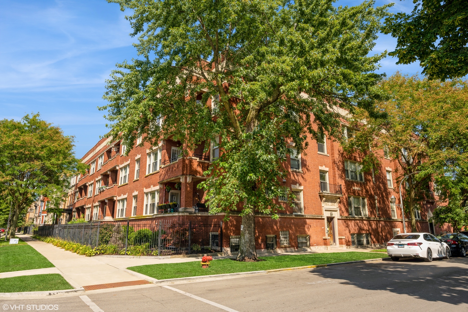 a front view of a building with trees