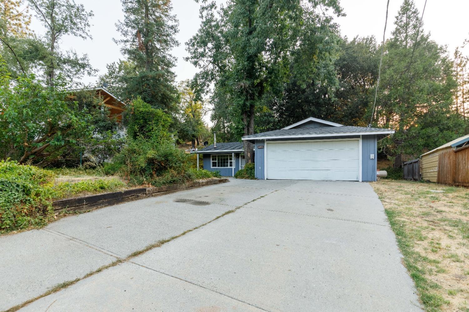 a front view of a house with trees