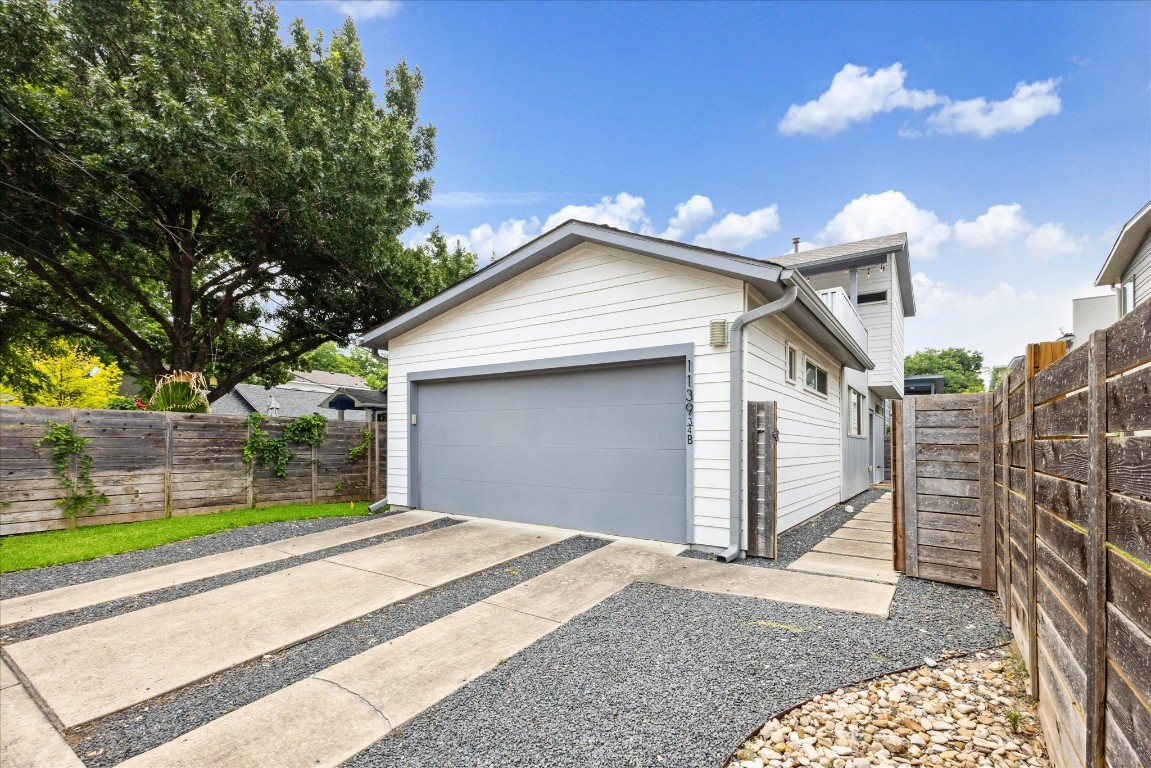 Dedicated driveway, two car garage, and entry to the front door