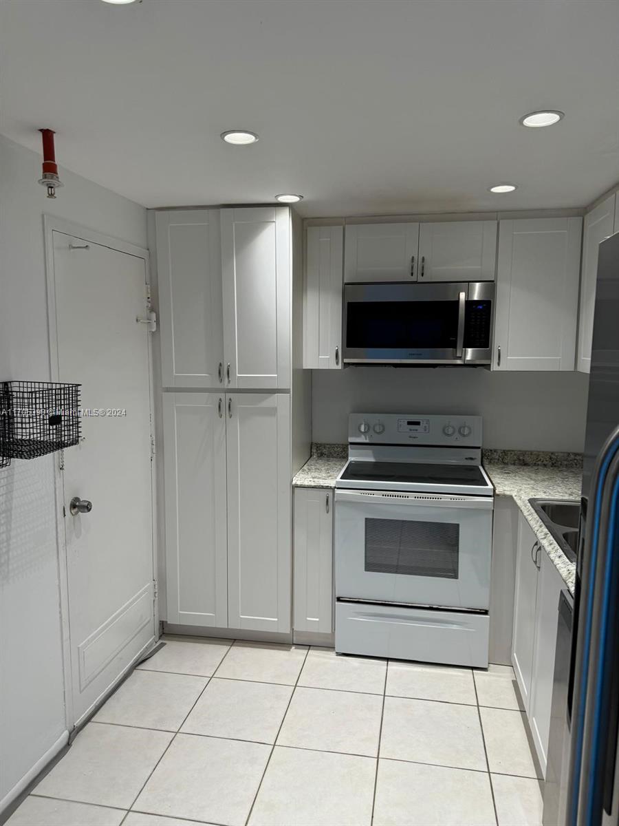 a kitchen with a stove and a refrigerator