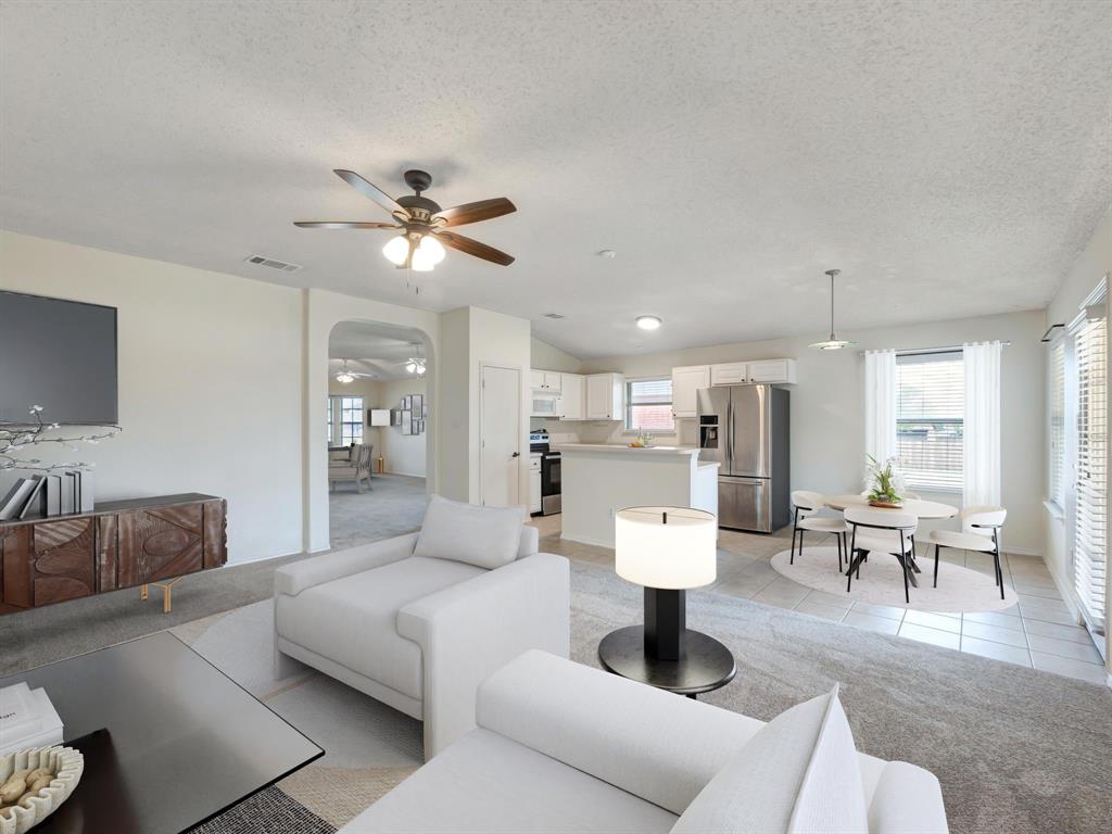 a living room with furniture and kitchen view