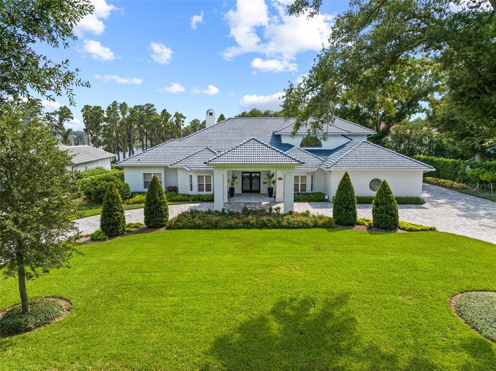 a front view of a house with yard and green space