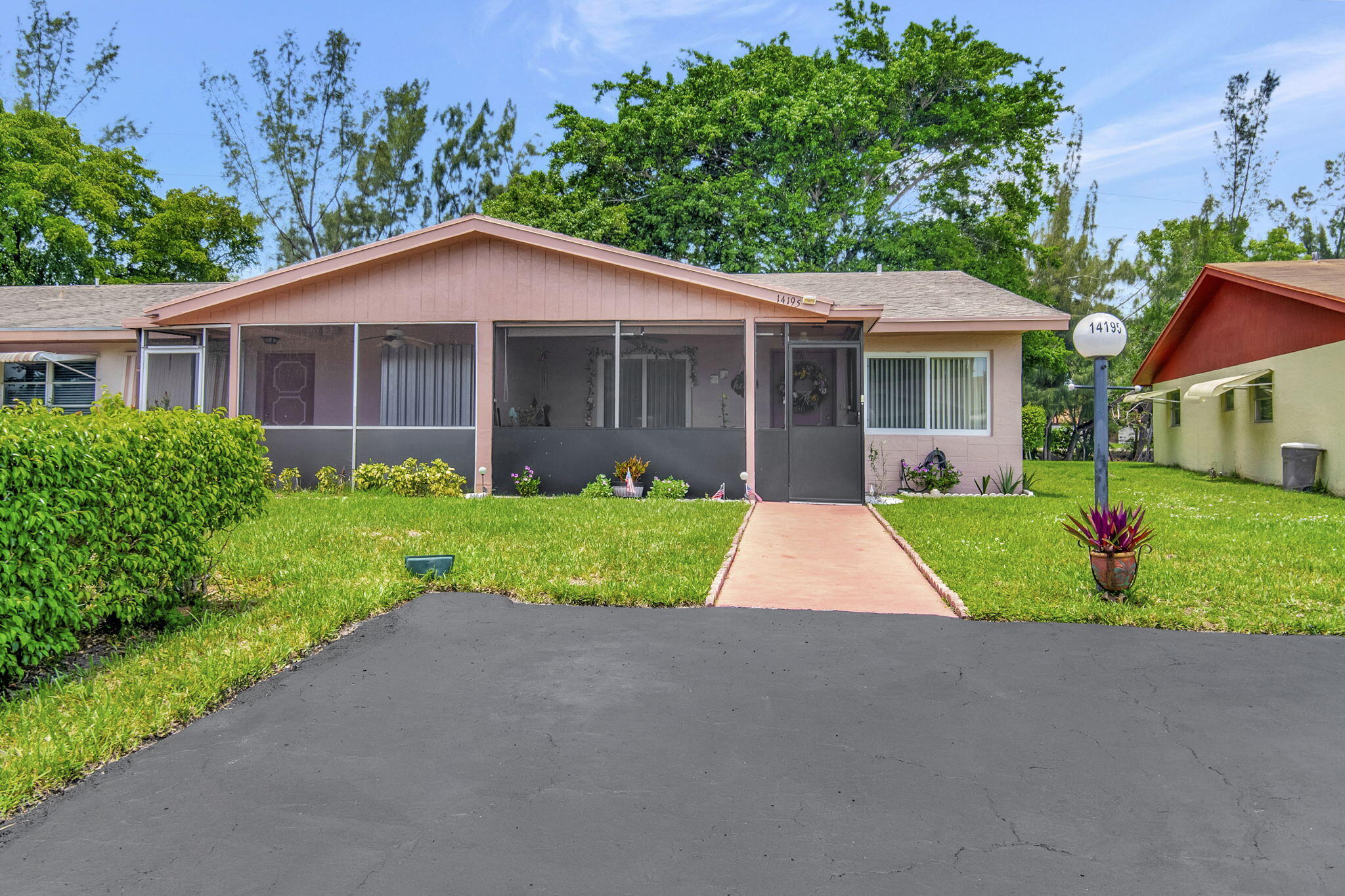 a view of a house with yard and plants