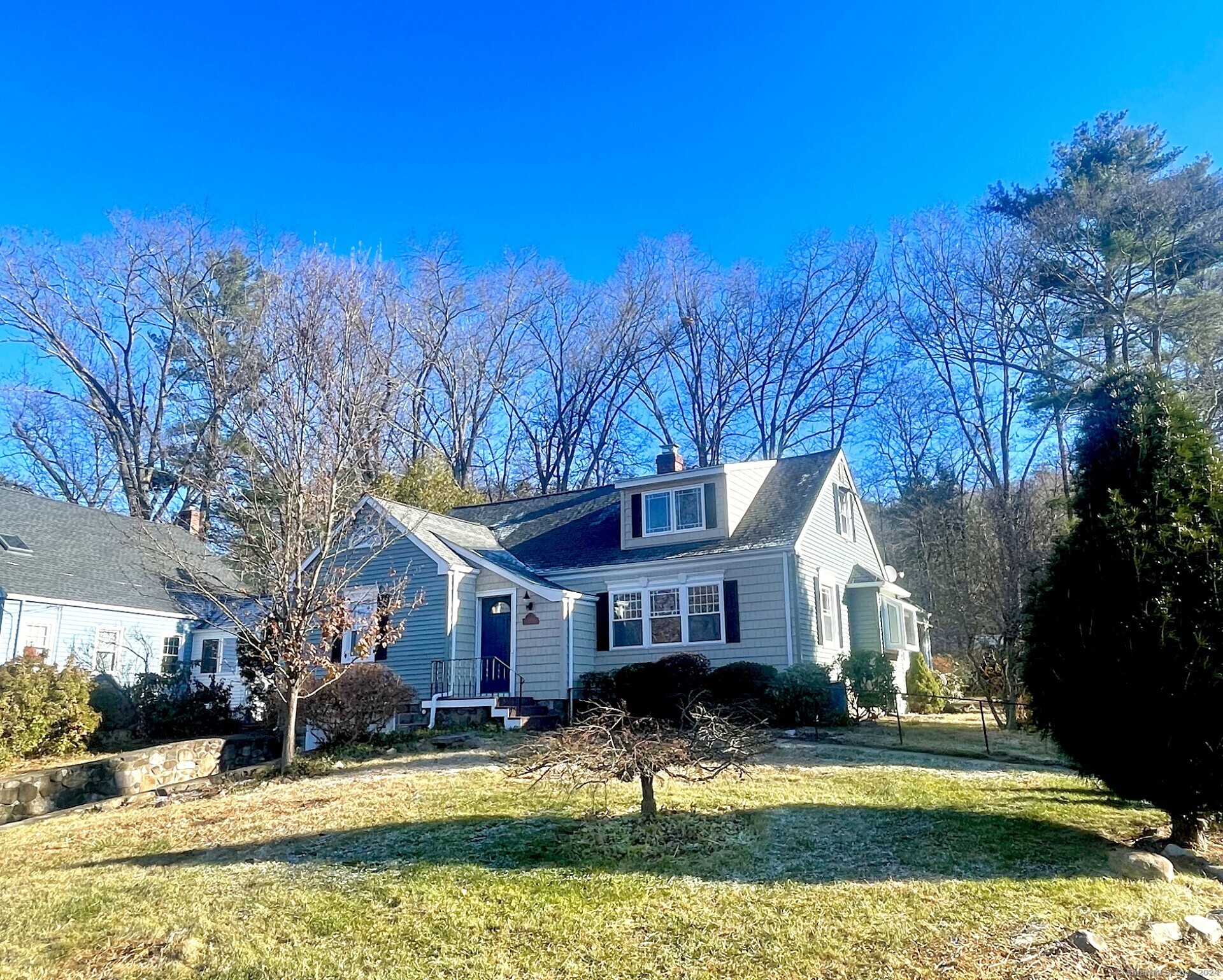 a view of a big house with a big yard and large tree