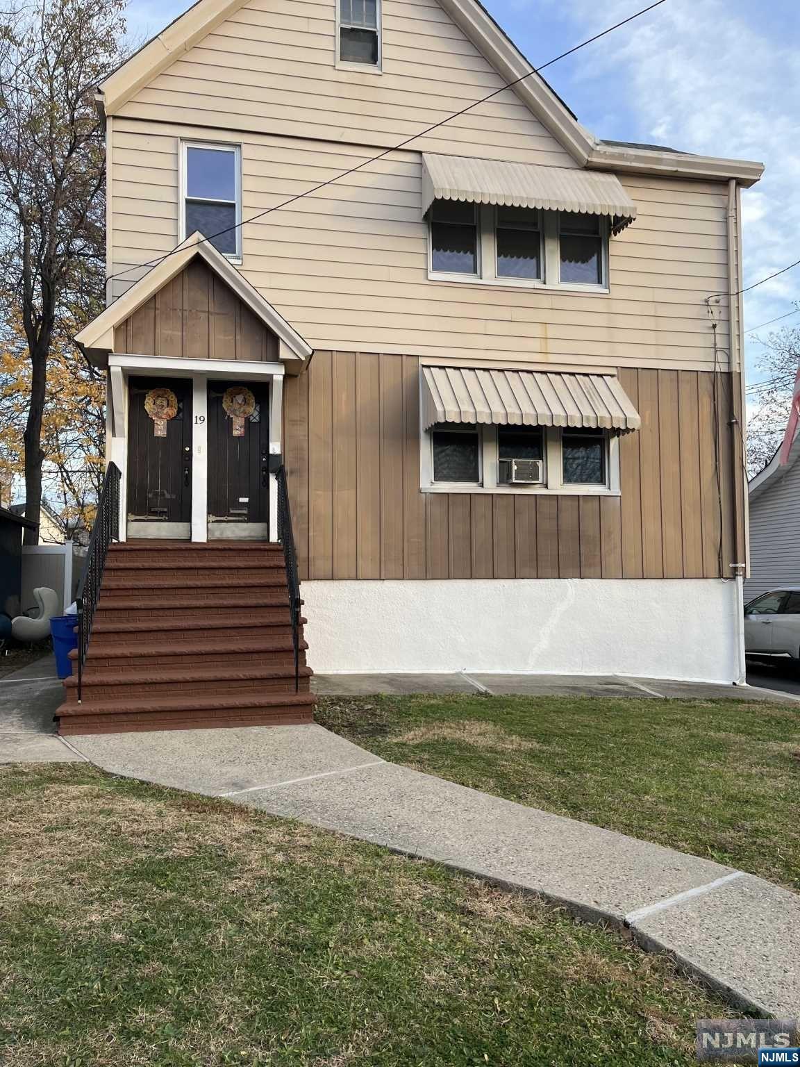 a front view of a house with a yard