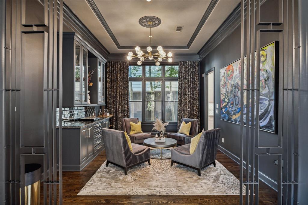 a living room with furniture and a chandelier