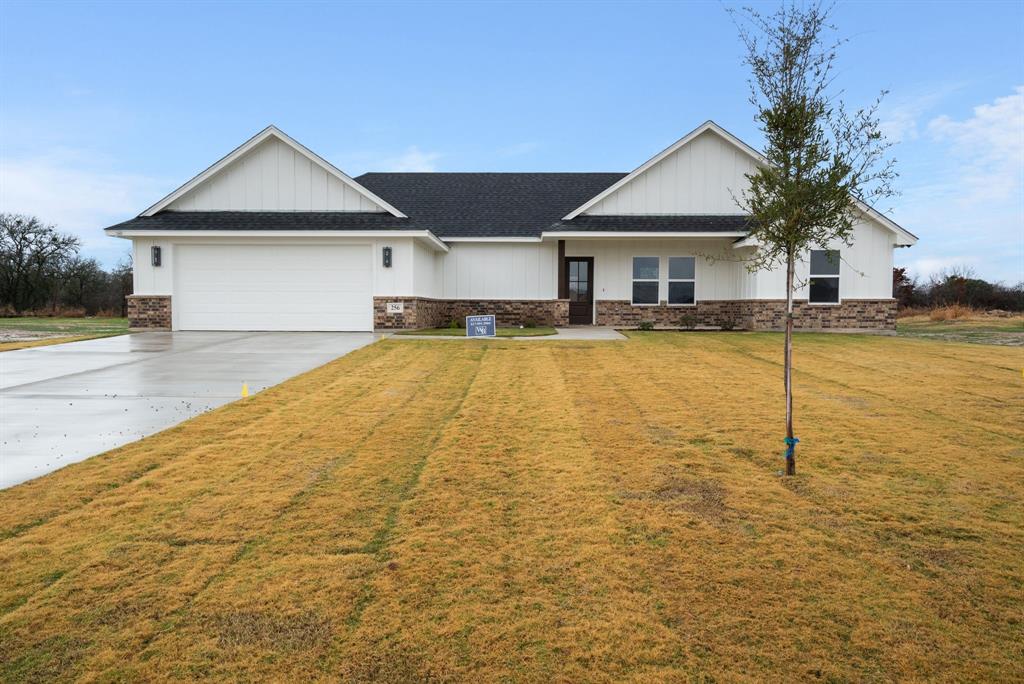 a front view of house with yard and swimming pool