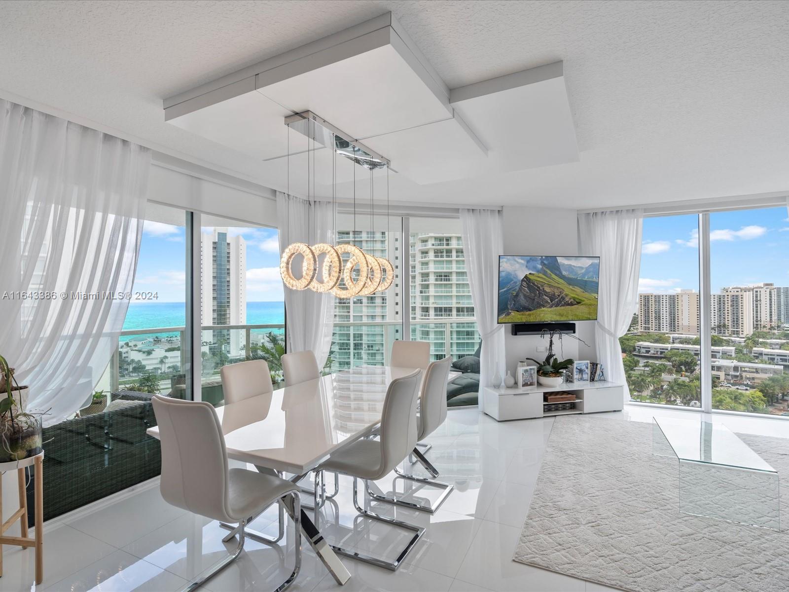 a view of a dining room with furniture water view and a floor to ceiling window