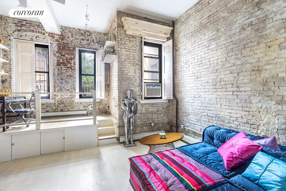 a bedroom with furniture and a large window