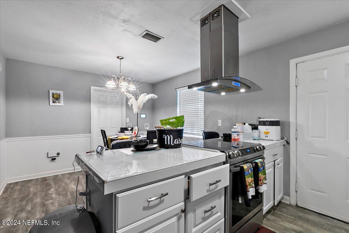 a kitchen with stainless steel appliances a sink a counter space and cabinets