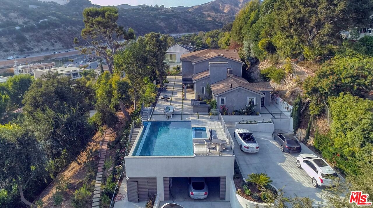 an aerial view of a house with garden space and street view