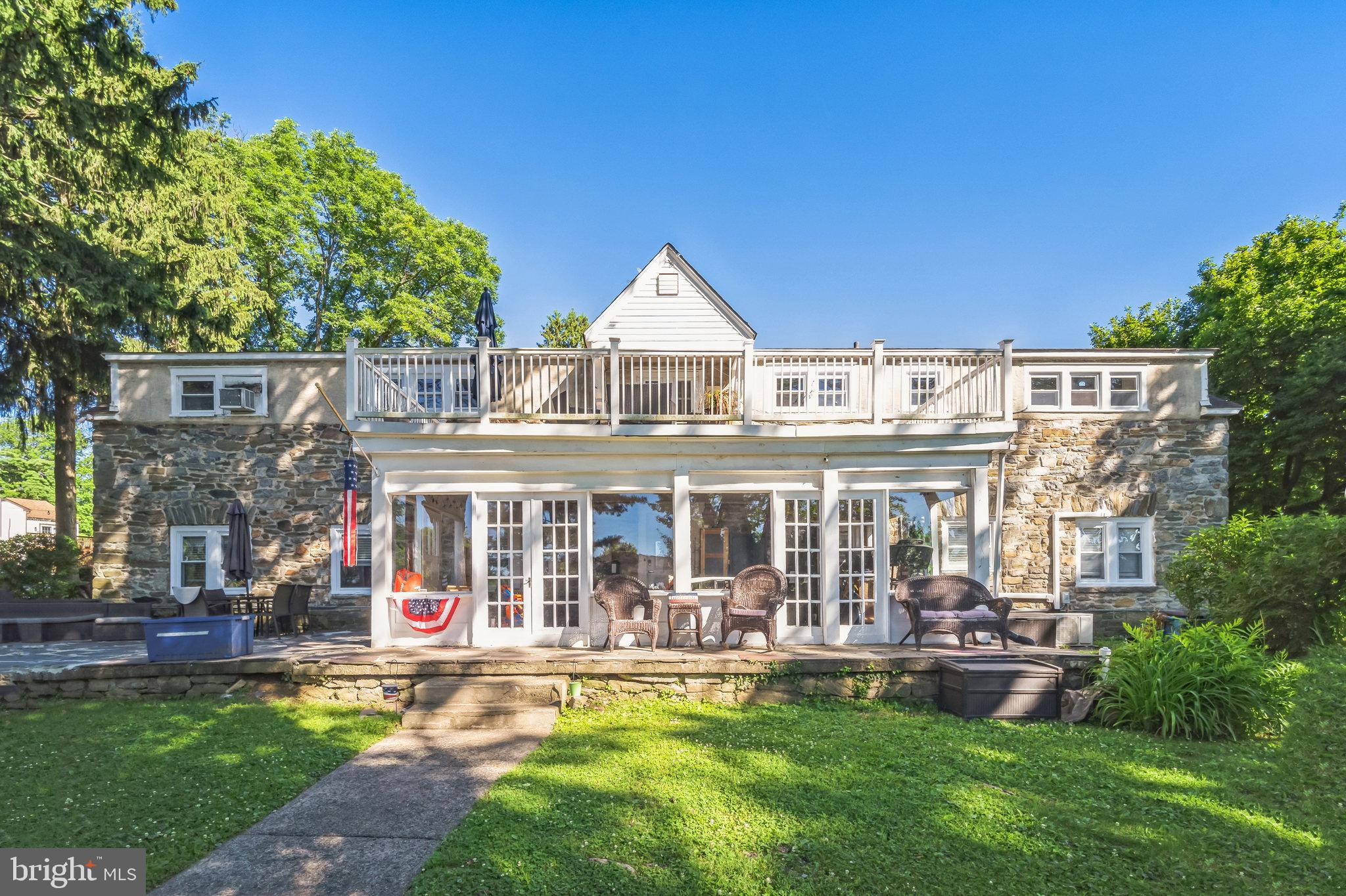 a front view of a house with swimming pool having outdoor seating