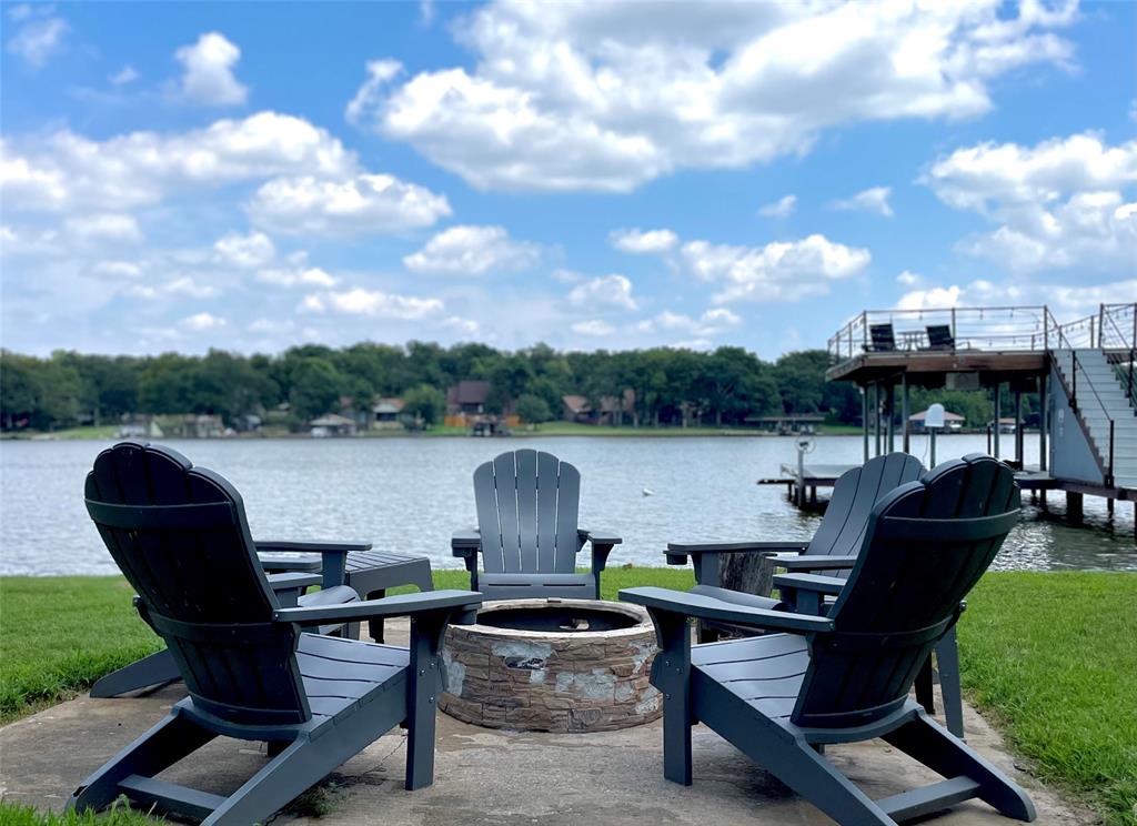 a view of a lake from a chairs and table in the back