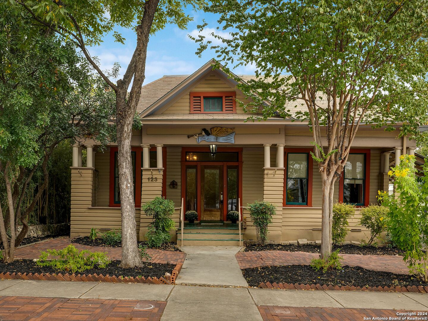 a front view of a house with garden