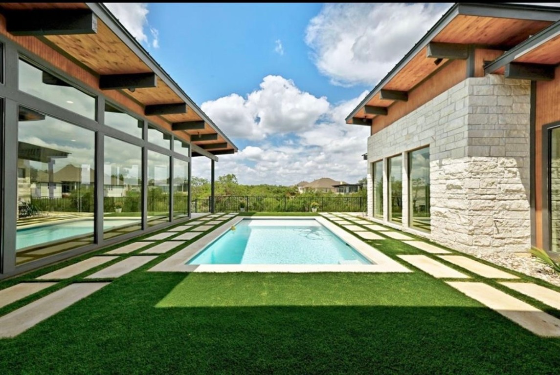 a view of swimming pool with a yard