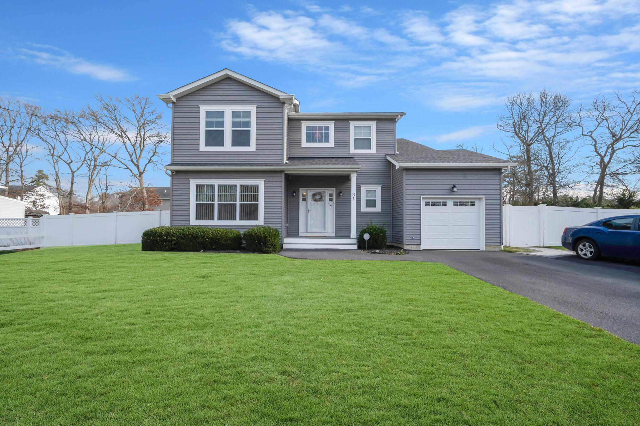 a front view of a house with a garden