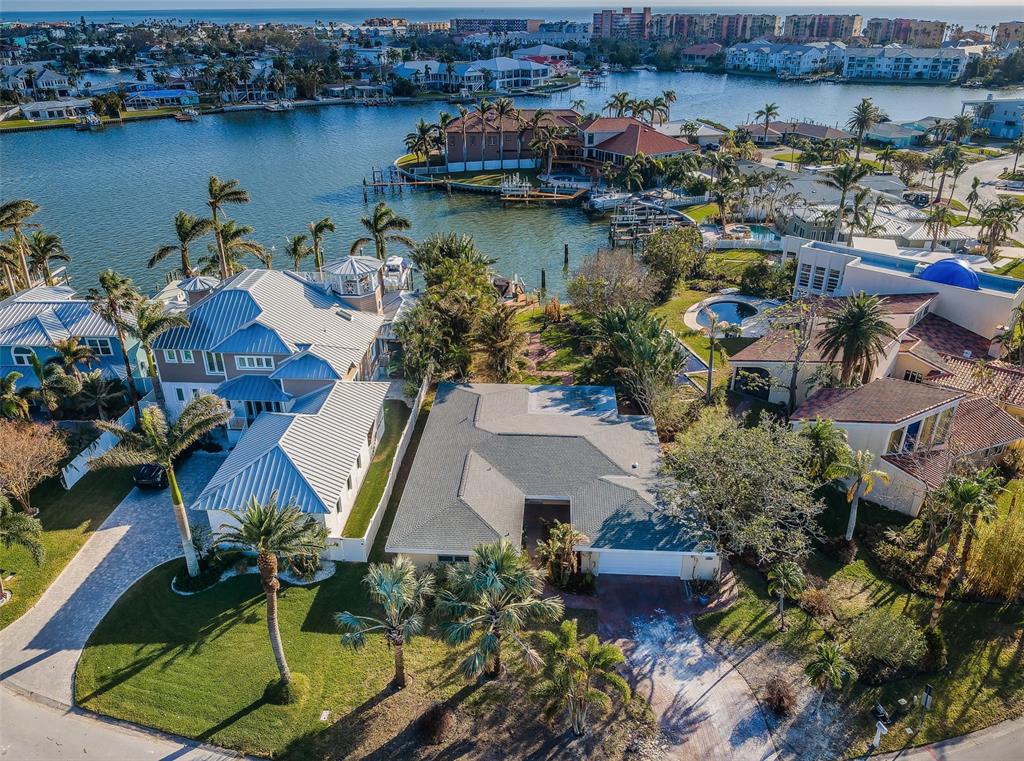 an aerial view of residential houses with outdoor space and lake view