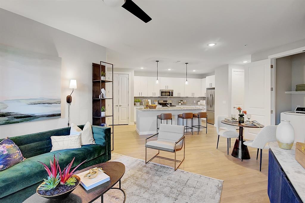 a living room with furniture and kitchen view