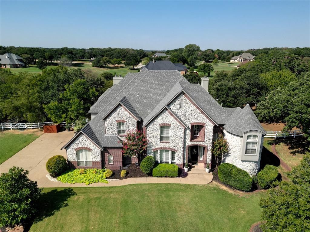 an aerial view of a house with a big yard