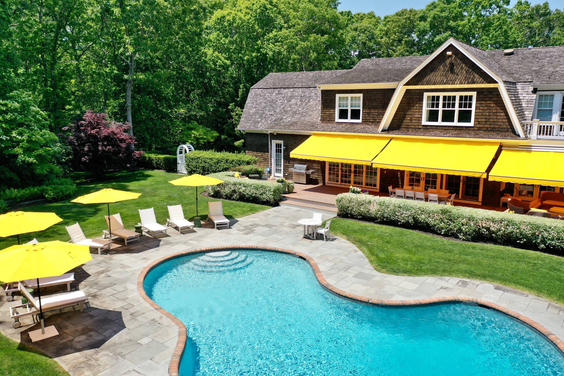 a aerial view of a house with swimming pool and patio