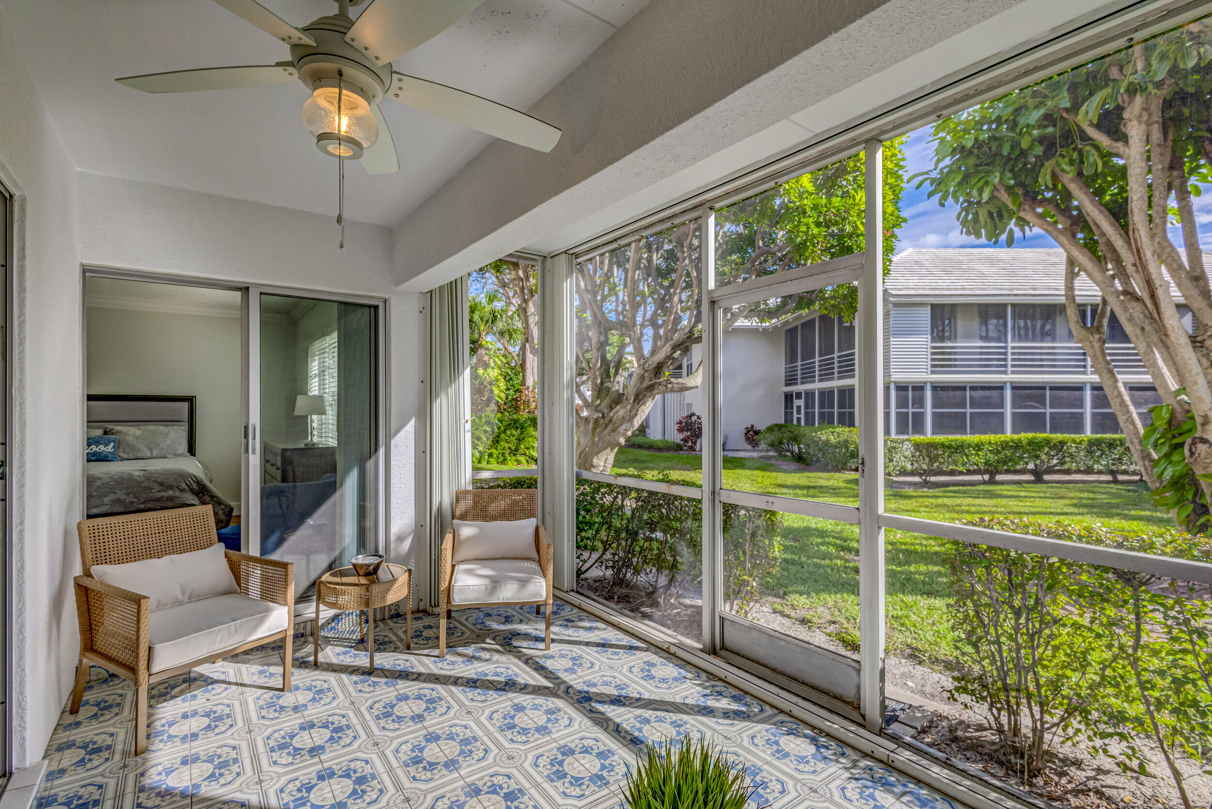 a view of a chair and table in patio with a backyard