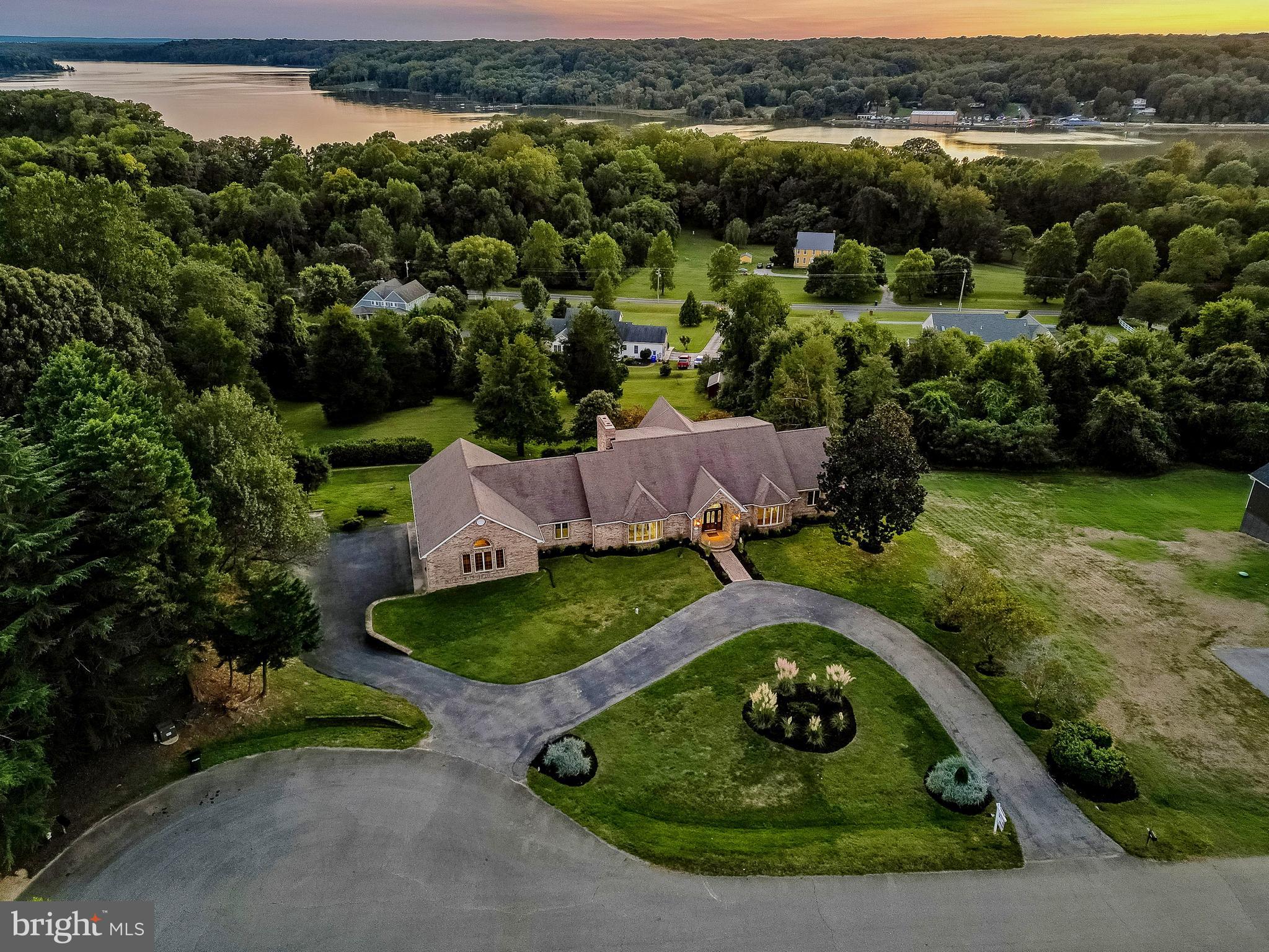 Aerial view of property at twilight.