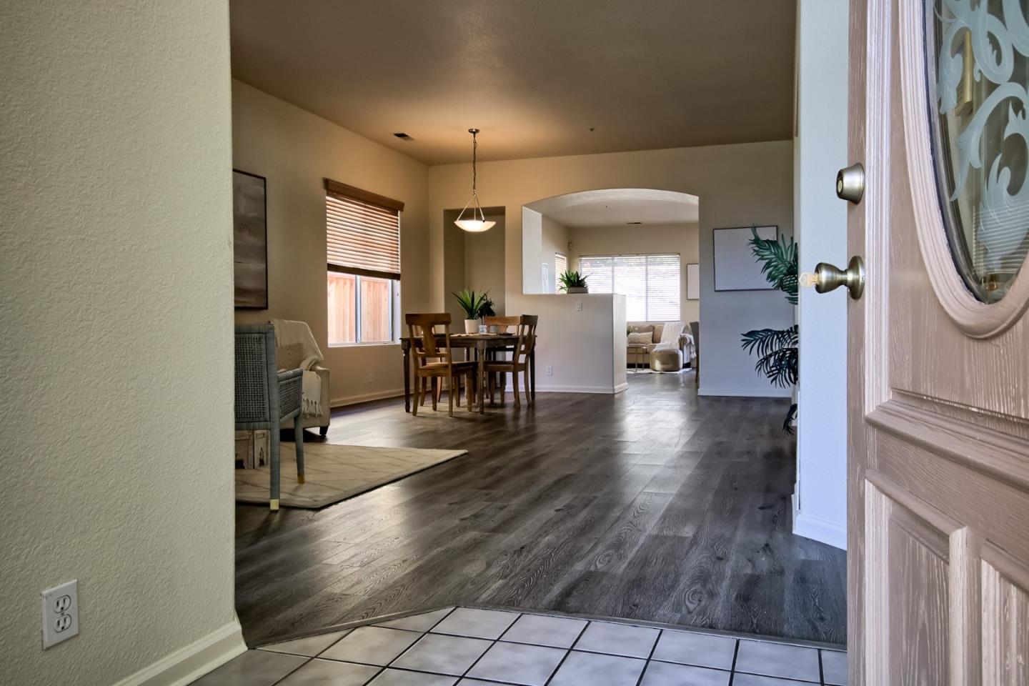 a view of a hallway with dining area a chandelier and fireplace