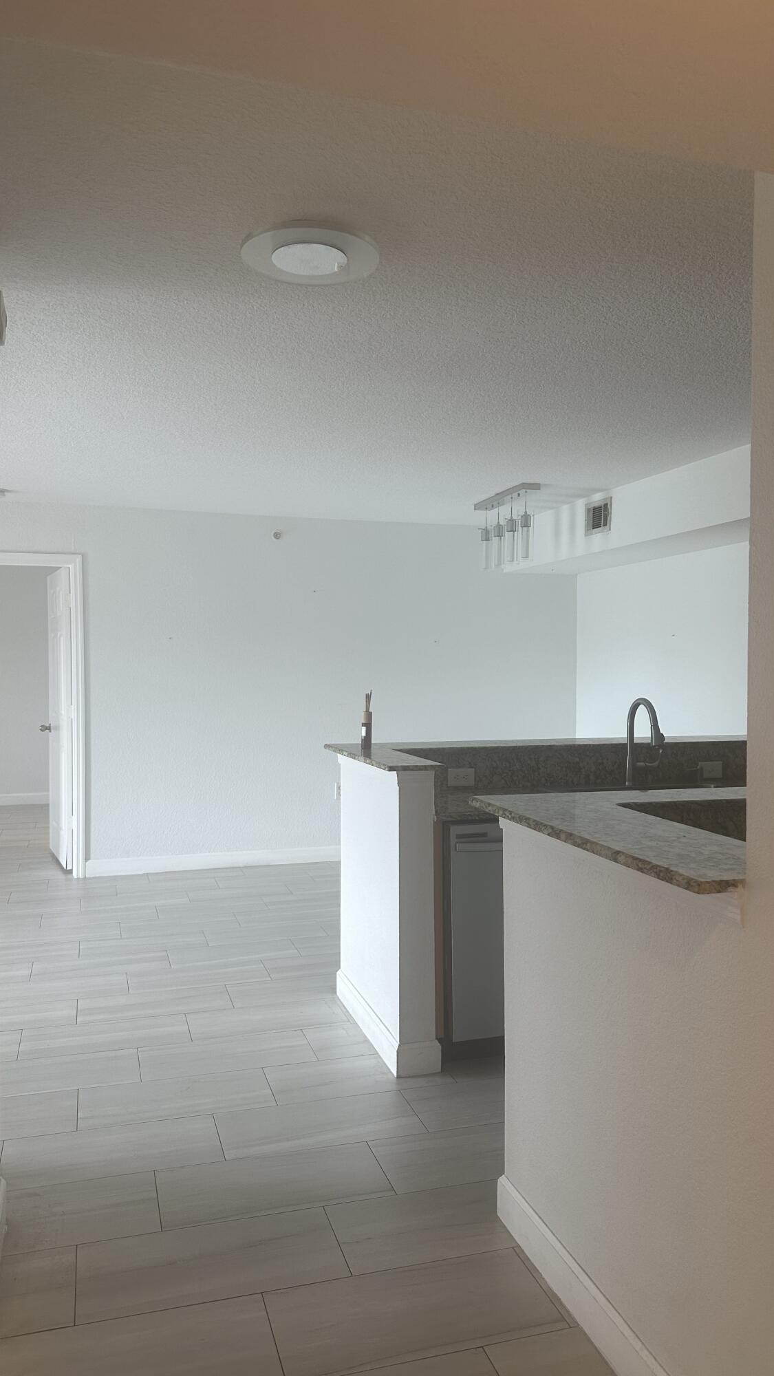 a kitchen with a sink cabinets and appliances