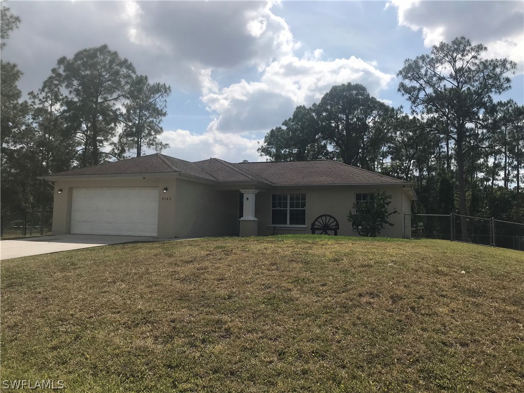 a front view of house with yard and trees